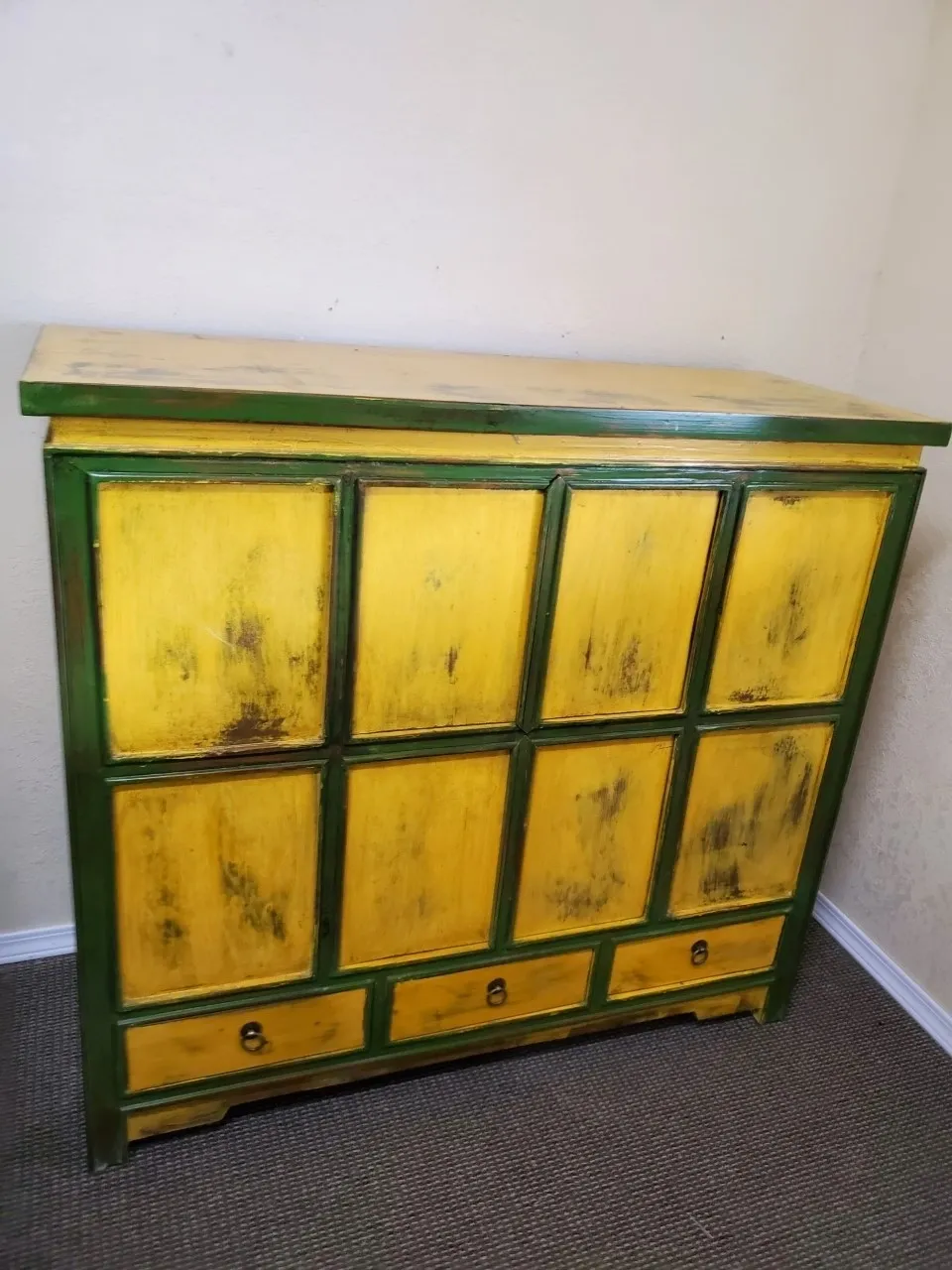 Yellow and green rustic wooden cabinet.