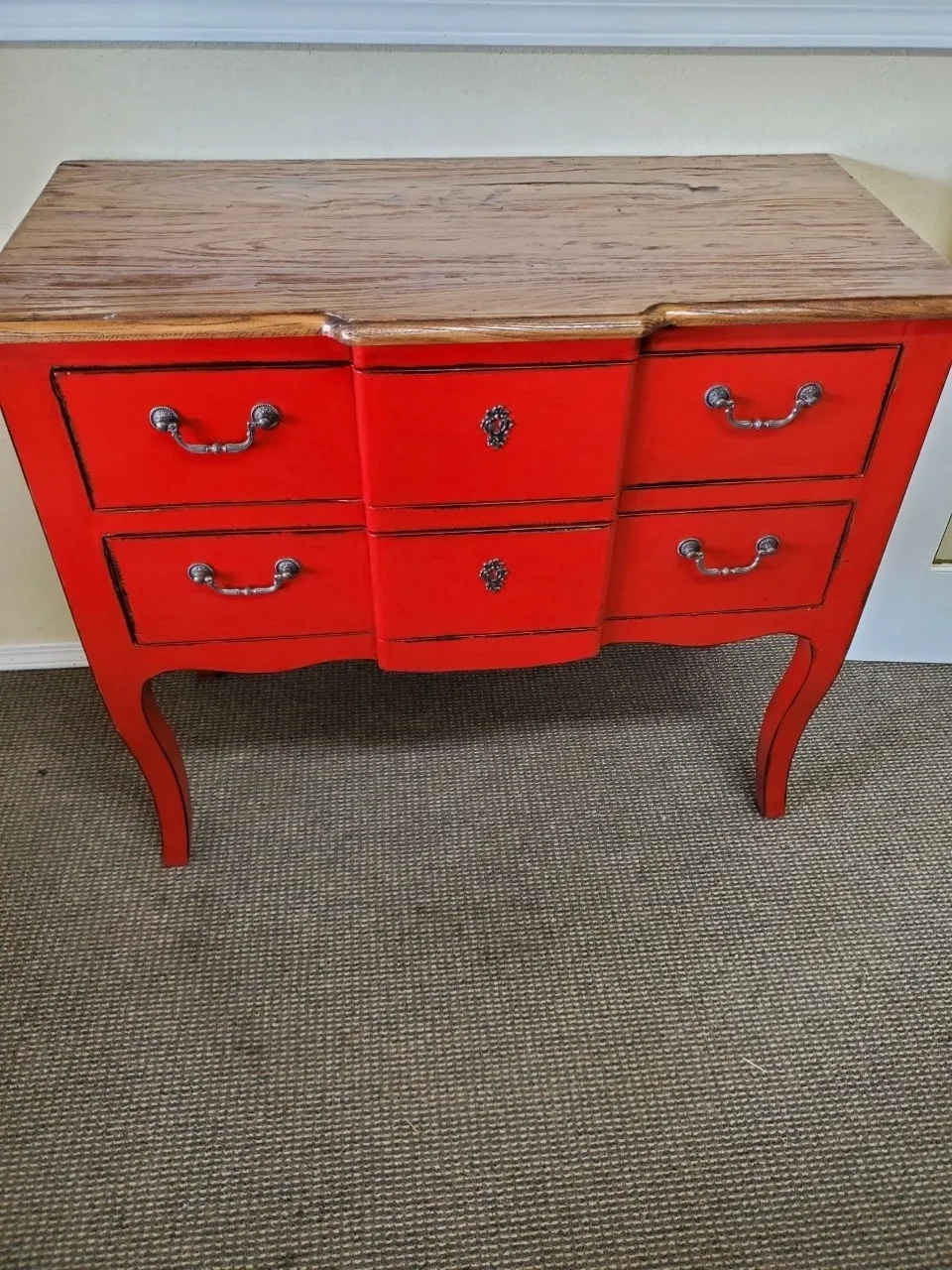 Red vintage dresser with wooden top.