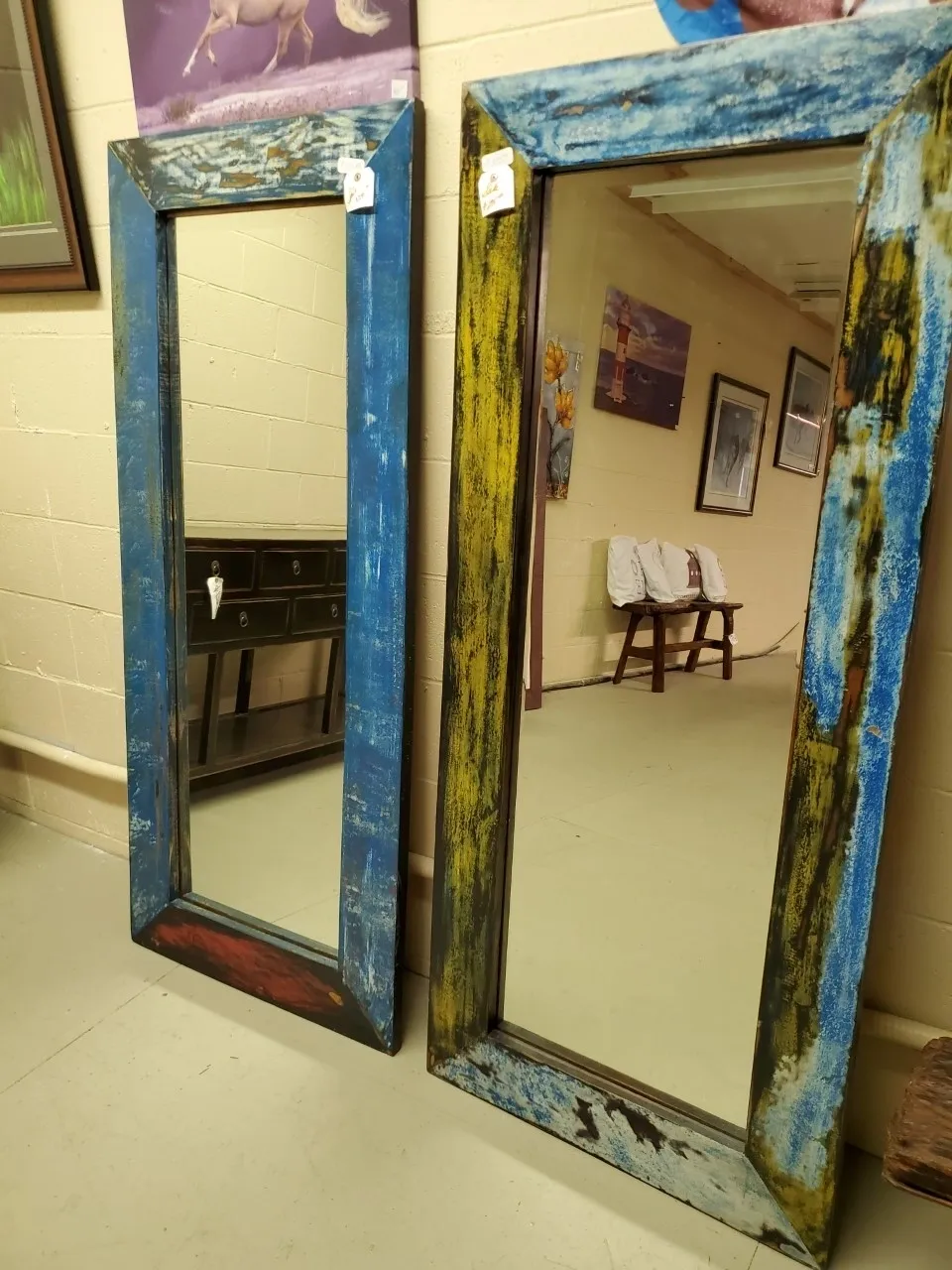 Two decorative mirrors with colorful frames.