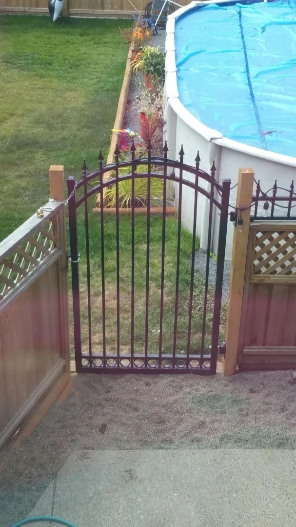 Garden gate near covered swimming pool.
