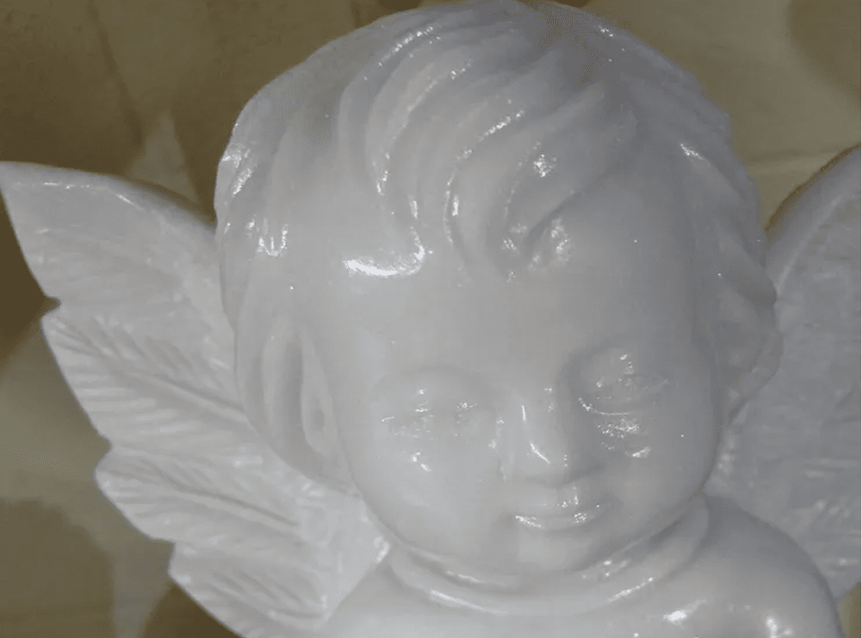 White angel statue with delicate facial features.