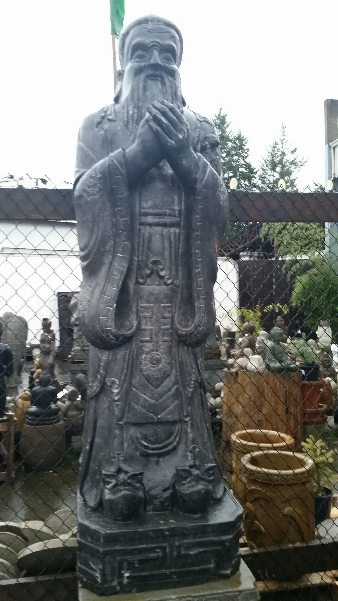 Stone statue of a standing bearded figure.