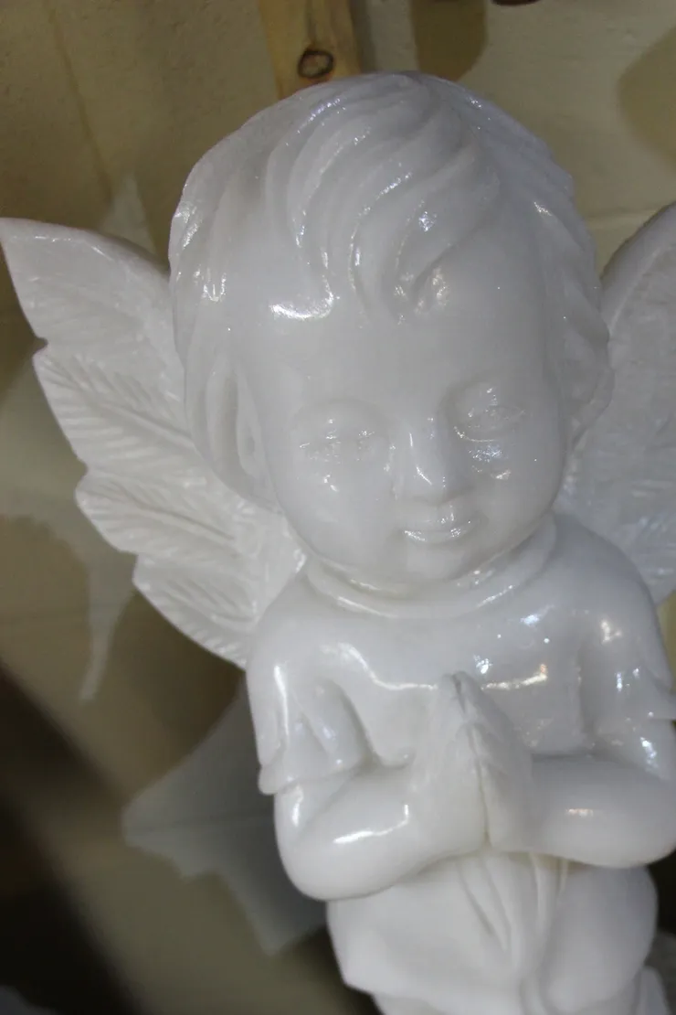 White marble angel figurine with wings.