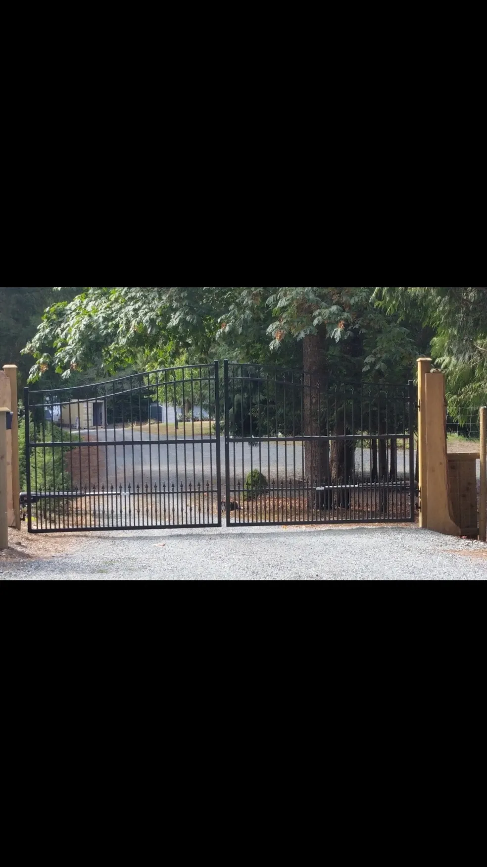 Iron gate with trees in the background.